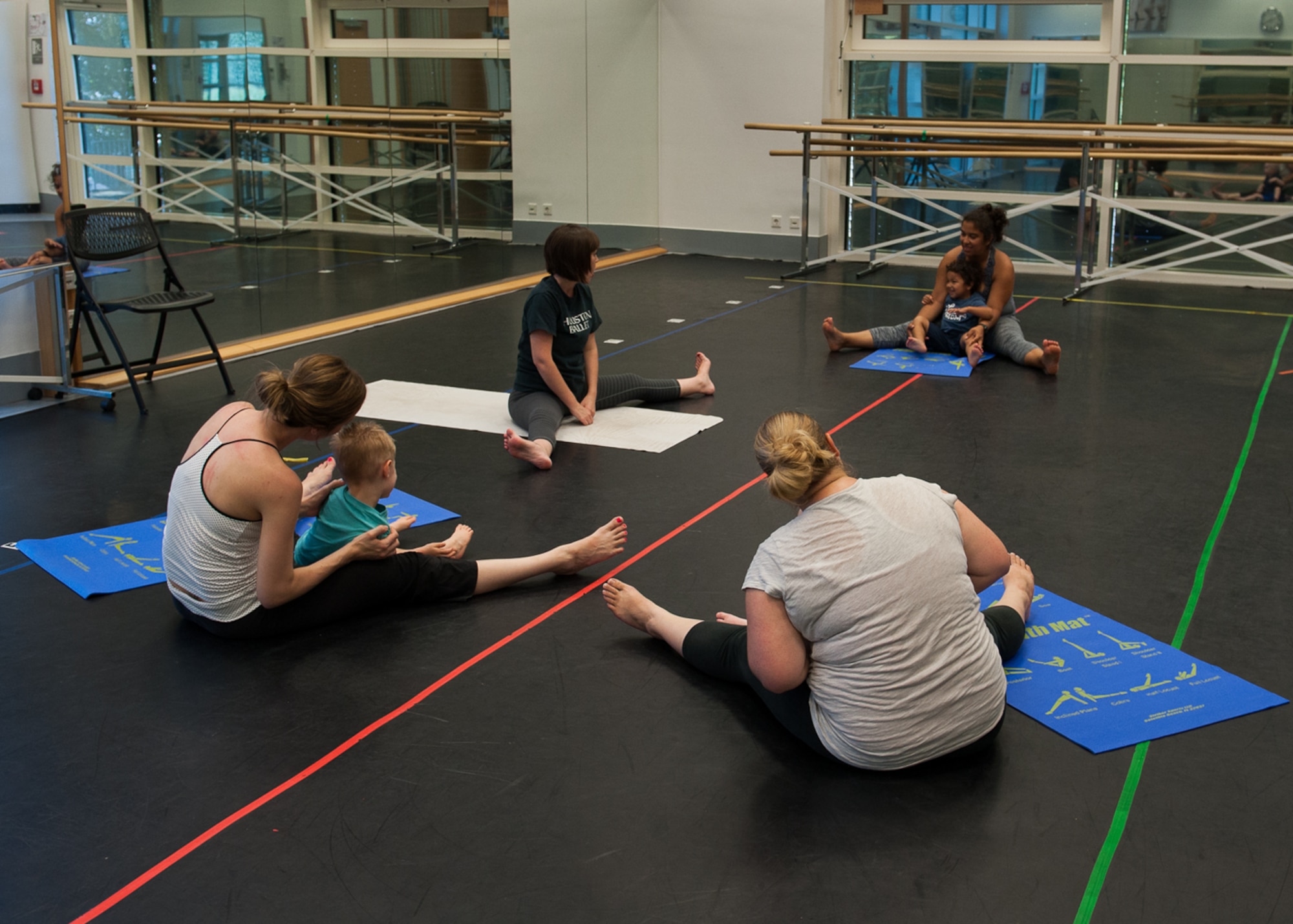 Students stretch before a Mommy and Me Yoga course hosted by the 86th Force Support Squadron Aug. 29, 2016, at Ramstein Air Base, Germany. Children participating with their mothers must be between the ages of two and three to take the class. (U.S. Air Force photo/ Airman 1st Class Savannah L. Waters)
