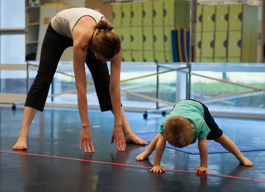 Jackson Parnell joins his mother, Brandy Parnell, in a cool-down stretch during the first Mommy and Me Yoga class Aug. 29, 2016, at Ramstein Air Base, Germany. The instructor incorporated nontraditional names for poses to keep the young children more engaged, as well as created an environment to promote a deeper mother-to-child bond. (U.S. Air Force 
photo/ Airman 1st Class Savannah L. Waters)
