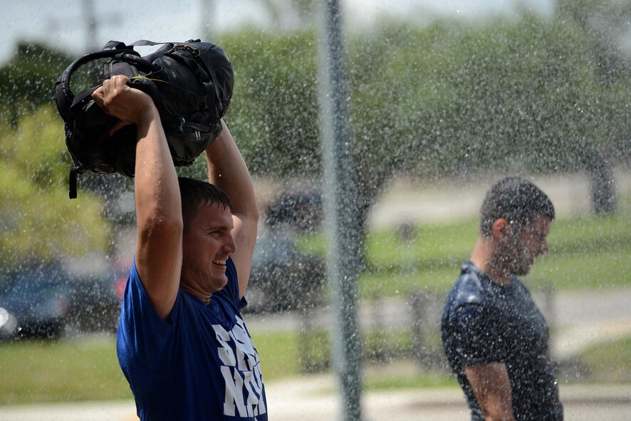 Captain Kenneth Molleson, 47th Operations Support Squadron assistant operations officer, endures a water exercise in the Team Cohesion Challenge on Laughlin Air Force Base, Texas, Aug. 27, 2016. The Team Cohesion Challenge incorporated many obstacles for participants to overcome that tested their mental and physical capabilities. (U.S. Air Force photo/ Airman 1st Class Benjamin N. Valmoja)