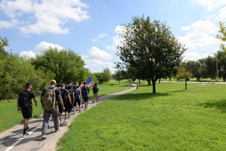 Team Cohesion Challenge participants ruck-march to their mock extraction point on Laughlin Air Force Base, Texas, Aug. 27, 2016. This GORUCK Light event had Laughlin’s participants rucking more than seven miles, carrying a 10 to 20 pound rucksack, transporting railroad ties, flipping tires, climbing rockwalls and conquering other physically challenging obstactle to test team work. (U.S. Air Force photo/Airman 1st Class Benjamin N. Valmoja)