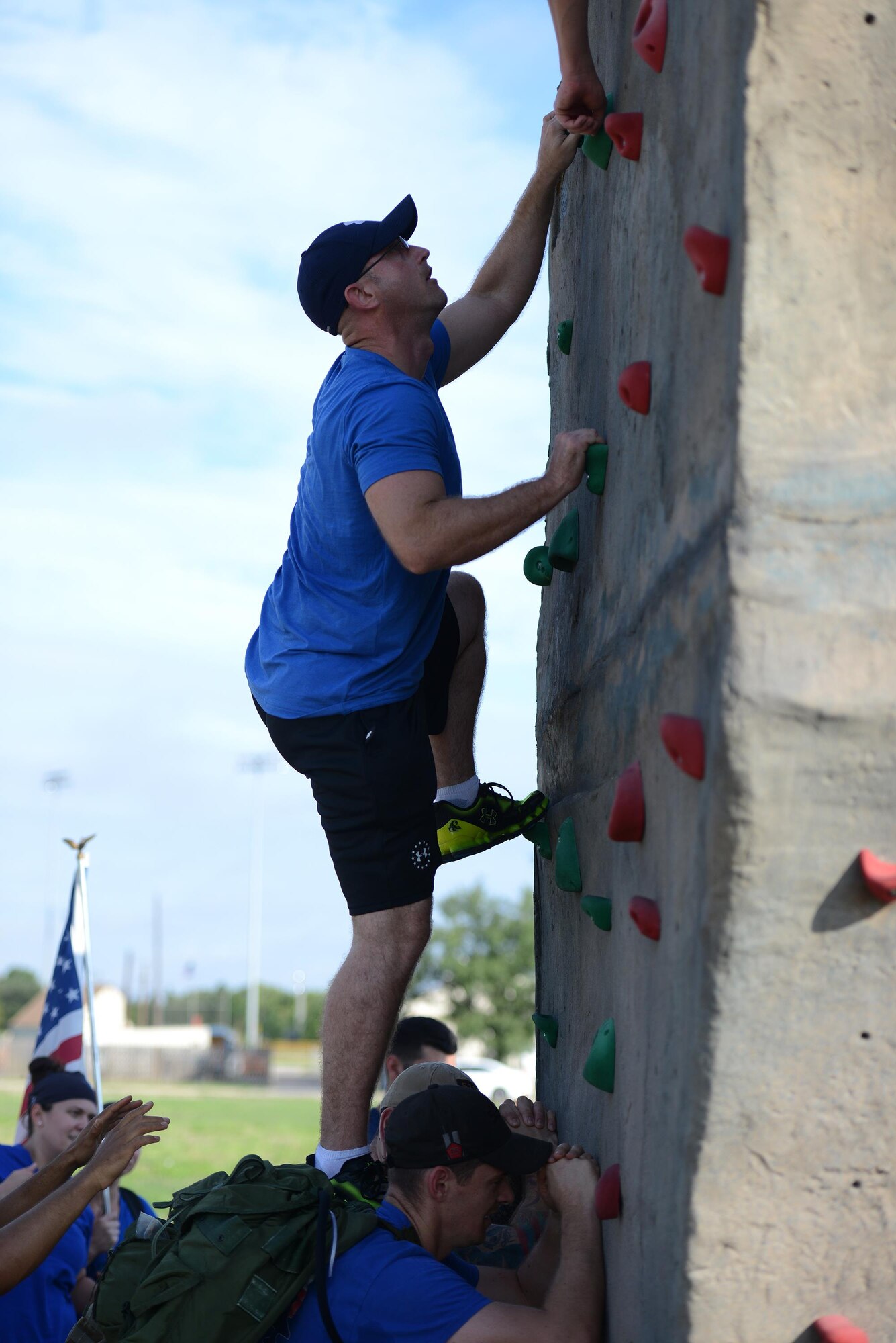 Staff Sgt. Richard McDonald, 47th Medical Support Squadron laboratory NCO in charge, is assisted by his teammates to scale the rock wall on Laughlin Air Force Base, Texas, Aug. 27, 2016. The goal of this event was to get all members of the team and their rucksacks over the rock wall in a timely manner without dropping any team members or rucksacks. (U.S. Air Force photo/Airman 1st Class Brandon May)