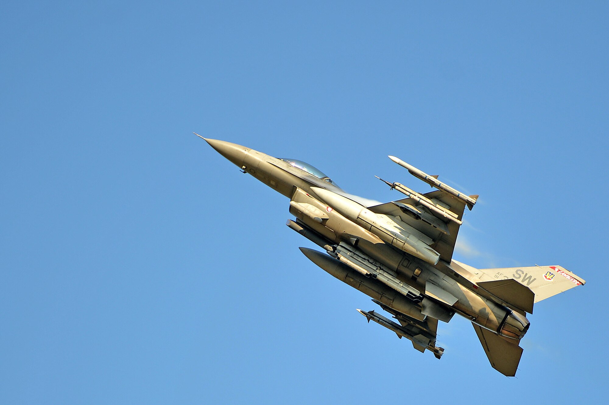 An F-16CM Fighting Falcon assigned to the 77th Fighter Squadron flies over Poinsett Electronic Combat Range, Wedgefield, S.C., Aug. 26, 2016. The F-16 flew numerous strafe runs, bombing runs and other maneuvers for the onlookers below. (U.S. Air Force photo by Airman 1st Class Christopher Maldonado)