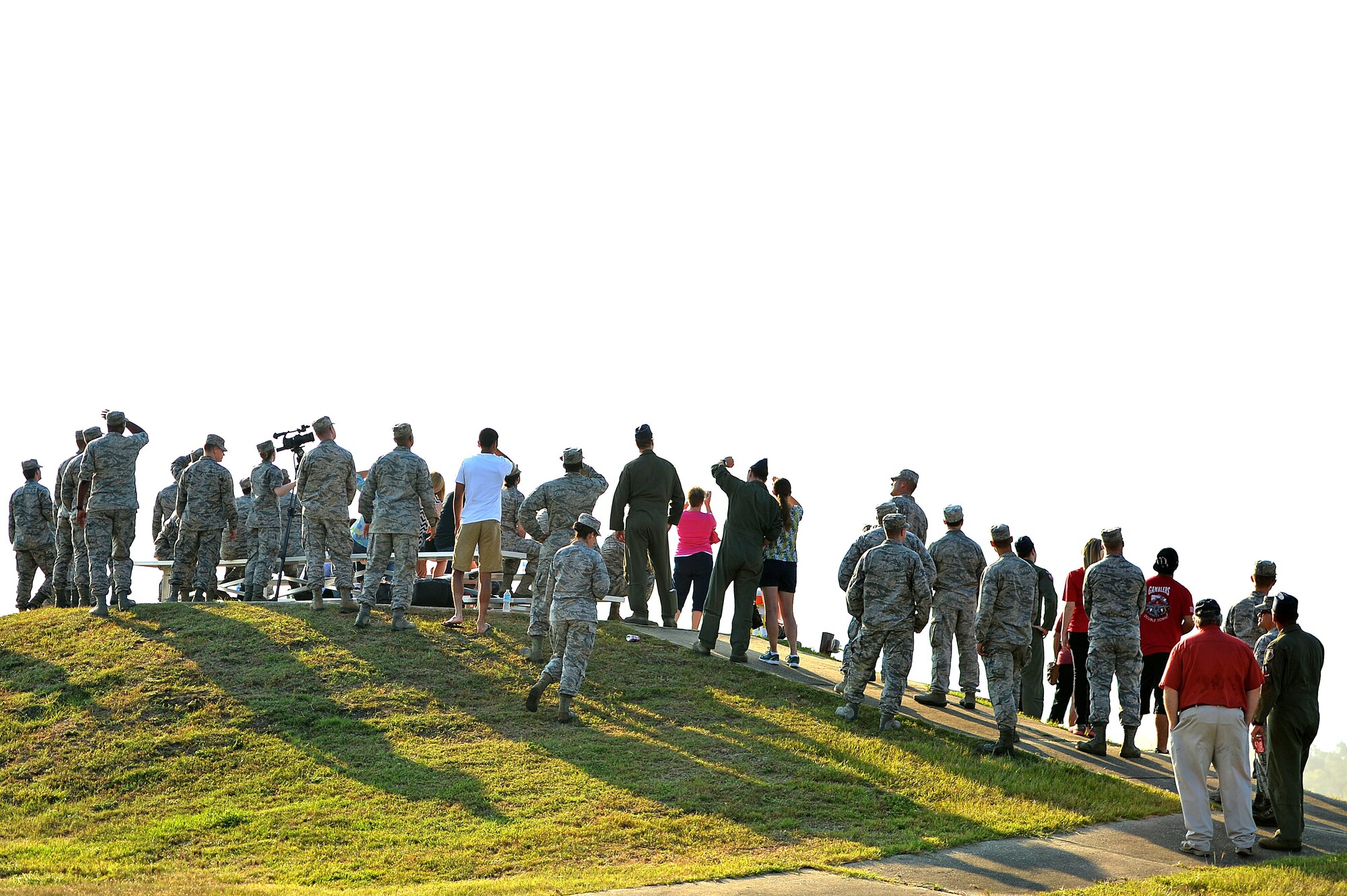U.S. Airmen assigned to the 77th Fighter Squadron and 20th Aircraft Maintenance Squadron observe F-16CM Fighting Falcons fly over during a family day at Poinsett Electronic Combat Range, Wedgefield, S.C., Aug. 26, 2016. Family members had the opportunity to see what their Airmen do on a daily basis to complete the mission. (U.S. Air Force photo by Airman 1st Class Christopher Maldonado)