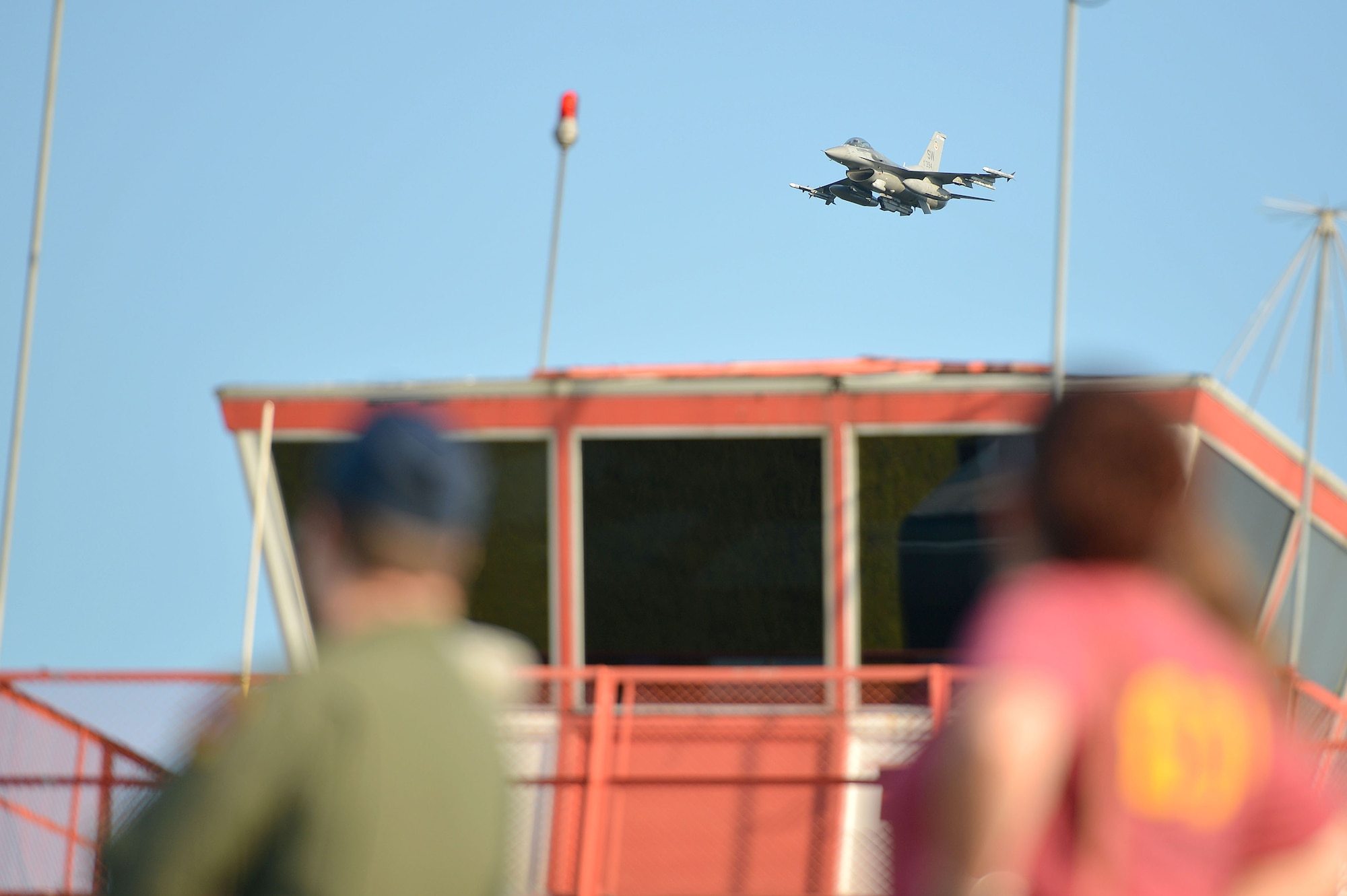 Team Shaw members assigned to the 77th Fighter Squadron and 20th Aircraft Maintenance Squadron watch an F-16CM Fighting Falcon perform a strafing run at Poinsett Electronic Combat Range, Wedgefield, S.C., Aug. 26, 2016. Airmen from the 77th FS and 20th AMXS had the opportunity to show their family members what they work to accomplish on a daily basis. (U.S. Air Force photo by Airman 1st Class Christopher Maldonado)