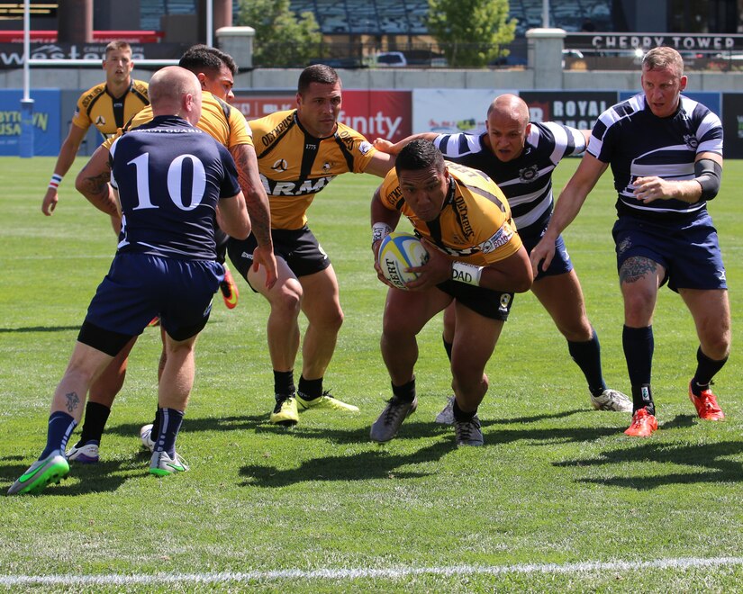 Sgt. Setu T. Lepou, combat engineer, 303rd Maneuver Enhancement Brigade, 9th Mission Support Command, pushes his way through his opponents (U.S. Coast Guard rugby team) and with the help of his All-Army teammates scores the first Try (score) of the day during day two of the U.S. Armed Force Rugby Sevens Championship, Infinity Park, Glendale, Colo., Aug 27.