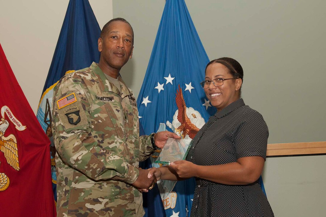 Actress Alex Ford, who portrayed Civil Rights heroine Rosa Parks during a Women’s Equality Day event Aug. 24 at Defense Logistics Agency Troop Support, signs a presidential flag while visiting the Flag Room. Ford detailed Parks’ life of activism and experiences that shaped her involvement in the Civil Rights Movement, including her difficulties gaining the right to vote.