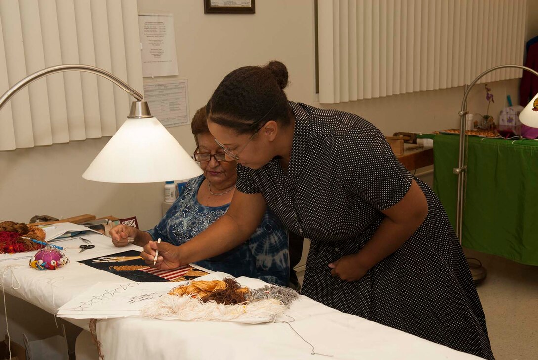 Actress Alex Ford, who portrayed Civil Rights heroine Rosa Parks during a Women’s Equality Day event Aug. 24 at Defense Logistics Agency Troop Support, signs a presidential flag while visiting the Flag Room. Ford detailed Parks’ life of activism and experiences that shaped her involvement in the Civil Rights Movement, including her difficulties gaining the right to vote.