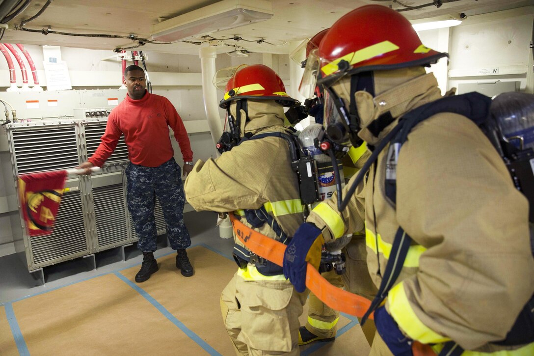 Sailors simulate fighting a fire during a general quarters drill aboard the aircraft carrier USS Gerald R. Ford at Newport News, Va., Aug. 24, 2016. The training focused on damage control and emergency responses. The sailors are assigned to the Pre-Commissioning Unit Gerald R. Ford. Navy photo by Seaman Gitte Schirrmacher