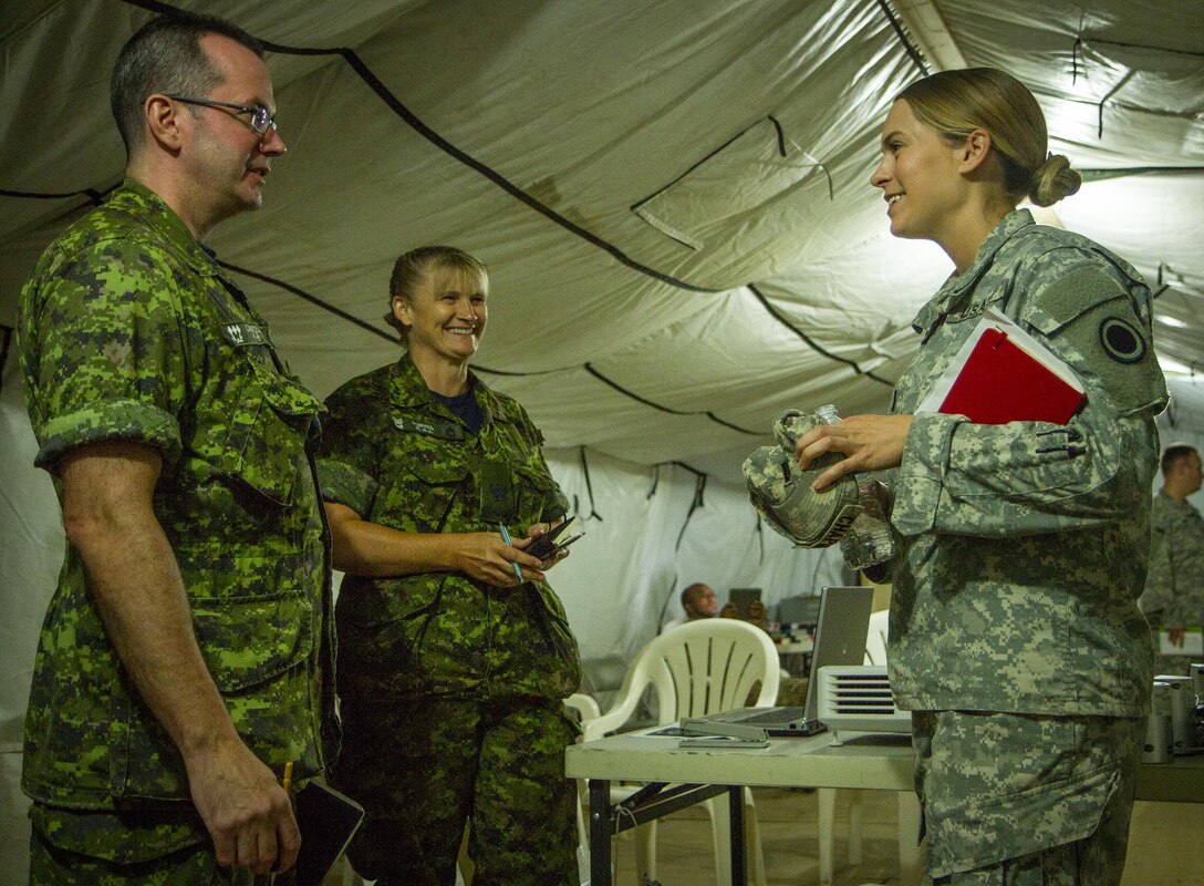 U.S. Army 1st Lt. Kelly Chapman, a logistics officer with I Corps who hails from Annapolis, Md., goes over redeployment plans with two Canadian soldiers during a two-week training exercise at Yongin, South Korea, Aug. 27, 2016. She and her fellow soldiers with the mayor's cell planned, organized, and executed a tent city that housed more than 500 U.S. and Canadian soldiers. (U.S. Army photo by Staff Sgt. Ken Scar)