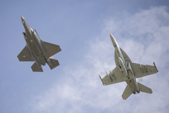An F-35A Lightning II and an FA-18 Super Hornet fly in formation over Volk Field, Wis., during Northern Lightning on Aug. 23, 2016. Northern Lightning is a tactical-level, joint training exercise that emphasizes fifth- and fourth-generation assets engaged in a contested, degraded environment. (U.S. Air Force photo/Senior Airman Stormy Archer)


