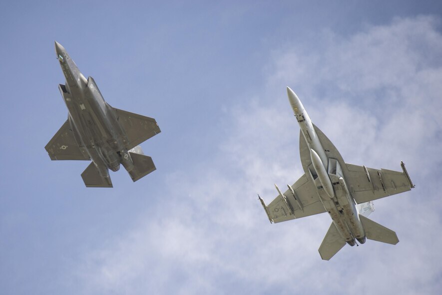 An F-35A and an FA-18 Super Hornet fly in formation over Volk Field Wis. during Northern Lightning, Aug. 23, 2016. Northern Lightning is a tactical-level, joint training exercise that emphasizes fifth and fourth generation assets engaged in a contested, degraded environment. (U.S. Air Force photo by Senior Airman Stormy Archer)

