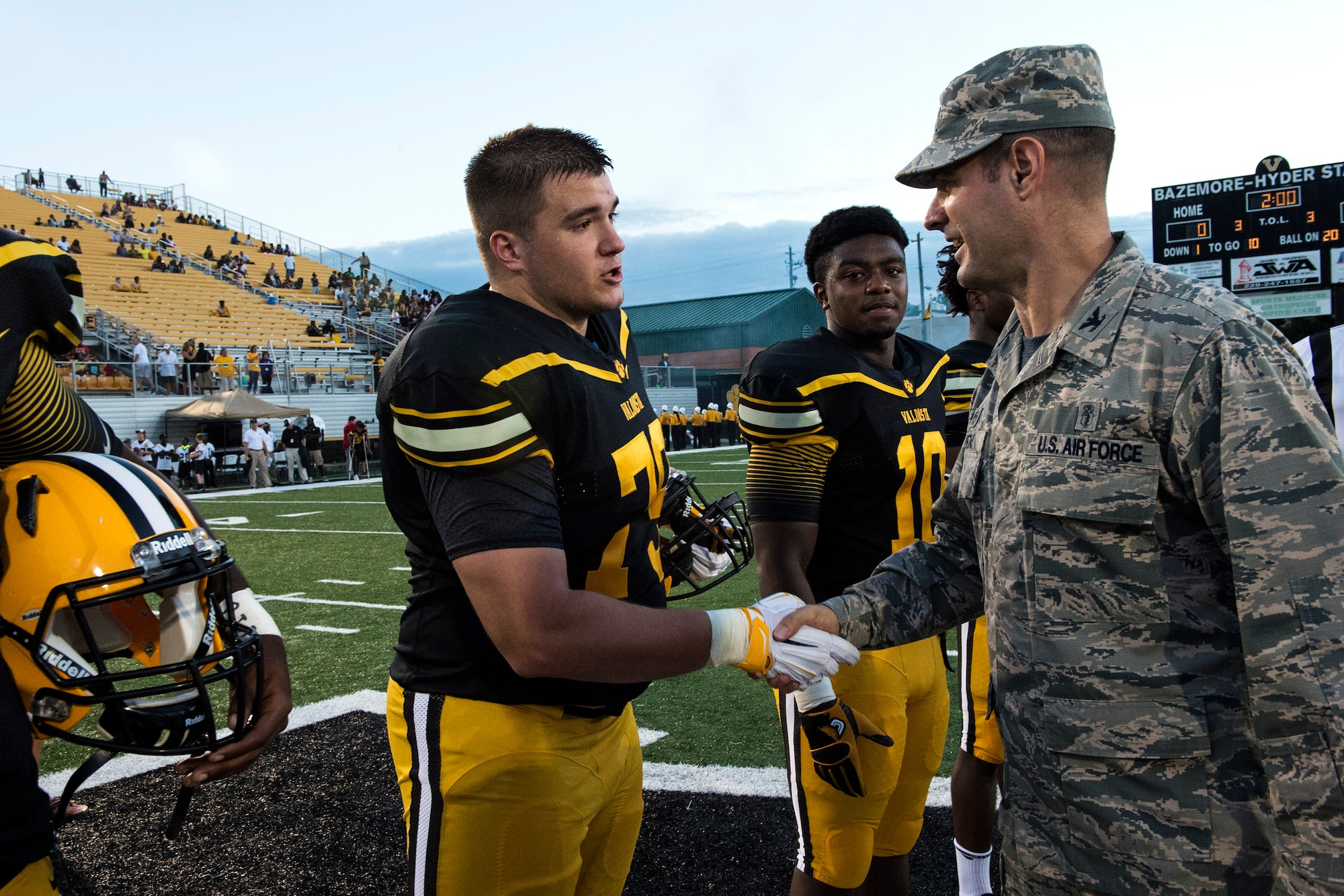U.S. Air Force Col. Jay Vietas, 23d Medical Group commander, shakes hands with one of Valdosta High School’s team captains, Troy Bryan, during Military Appreciation Night, Aug. 26, 2016, in Valdosta, Ga. This was the second game of the season for the VHS Wildcats, who now hold a 2-0 record. (U.S. Air Force photo by Airman 1st Class Janiqua P. Robinson)