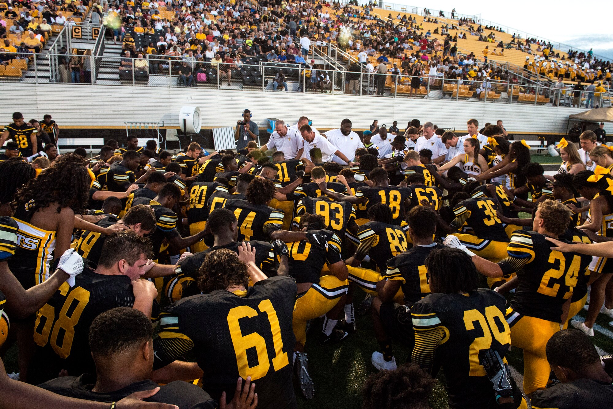 Valdosta High School Wildcats pray before the start of their game, Aug. 26, 2016, at Moody Air Force Base, Ga. The Wildcats recently celebrated their 900th win, becoming the first high school football program in the United States and second at any level to do so. (U.S. Air Force photo by Airman 1st Class Janiqua P. Robinson)
