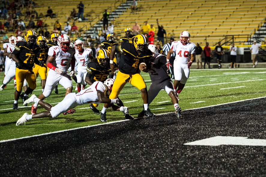 Josh Belton, quarterback and no. 4 for Valdosta High School, breaks several tackles while sprinting into the end zone during Military Appreciation Night, Aug. 26, 2016, in Valdosta, Ga. During this game Belton rushed for 96 yards, fumbled twice and completed 13 of 18 passes, throwing for a total of 240 yards. (U.S. Air Force photo by Airman 1st Class Janiqua P. Robinson)