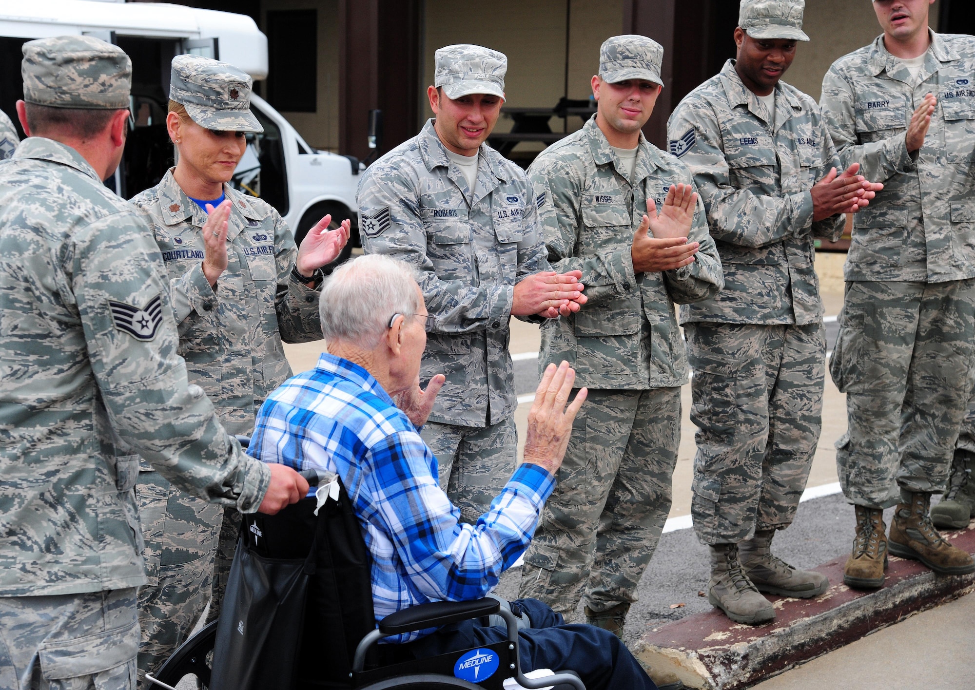 Volunteers from the 509th Logistics Readiness Squadron welcome veterans from the Missouri Veterans’ Home during a visit to Whiteman Air Force Base, Mo., Aug. 26, 2016. Approximately 20 veterans toured Whiteman and received briefings from various units on base (U.S. Air Force photo by Senior Airman Joel Pfiester)