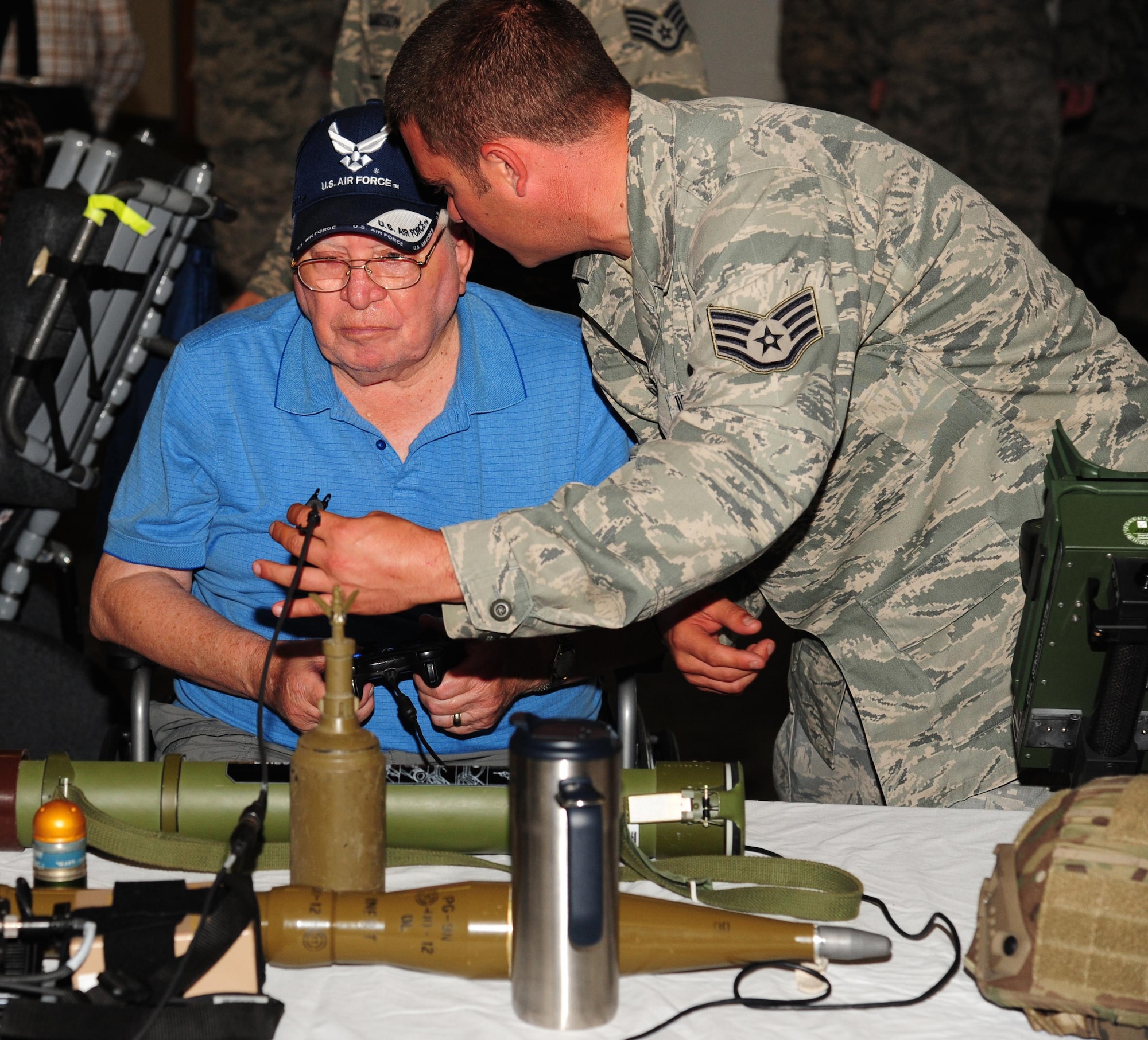 U.S. Air Force Staff Sgt. Kyle Bemis, a vehicle maintenance manager from the 509th Logistics Readiness Squadron, describes some of the items on display to a veteran at Whiteman Air Force Base, Mo., Aug. 26, 2016. Veterans from the Missouri Veterans' Home visited Whiteman and learned about various squadrons on base and each unit’s mission. (U.S. Air Force photo by Senior Airman Joel Pfiester)