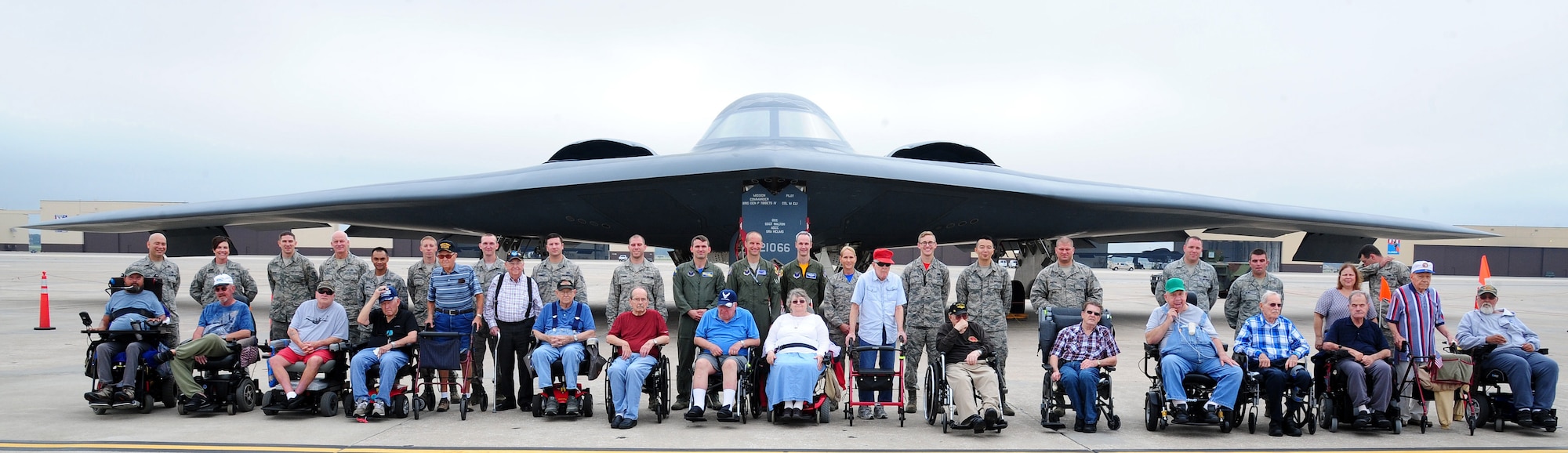 Veterans from the Missouri Veterans' Home and Airmen from Whiteman Air Force Base, Mo., pose in front of a B-2 Spirit at Whiteman, Aug. 26, 2016. After learning more about Whiteman’s mission, the veterans toured the B-2 Spirit. (U.S. Air Force photo by Senior Airman Joel Pfiester)