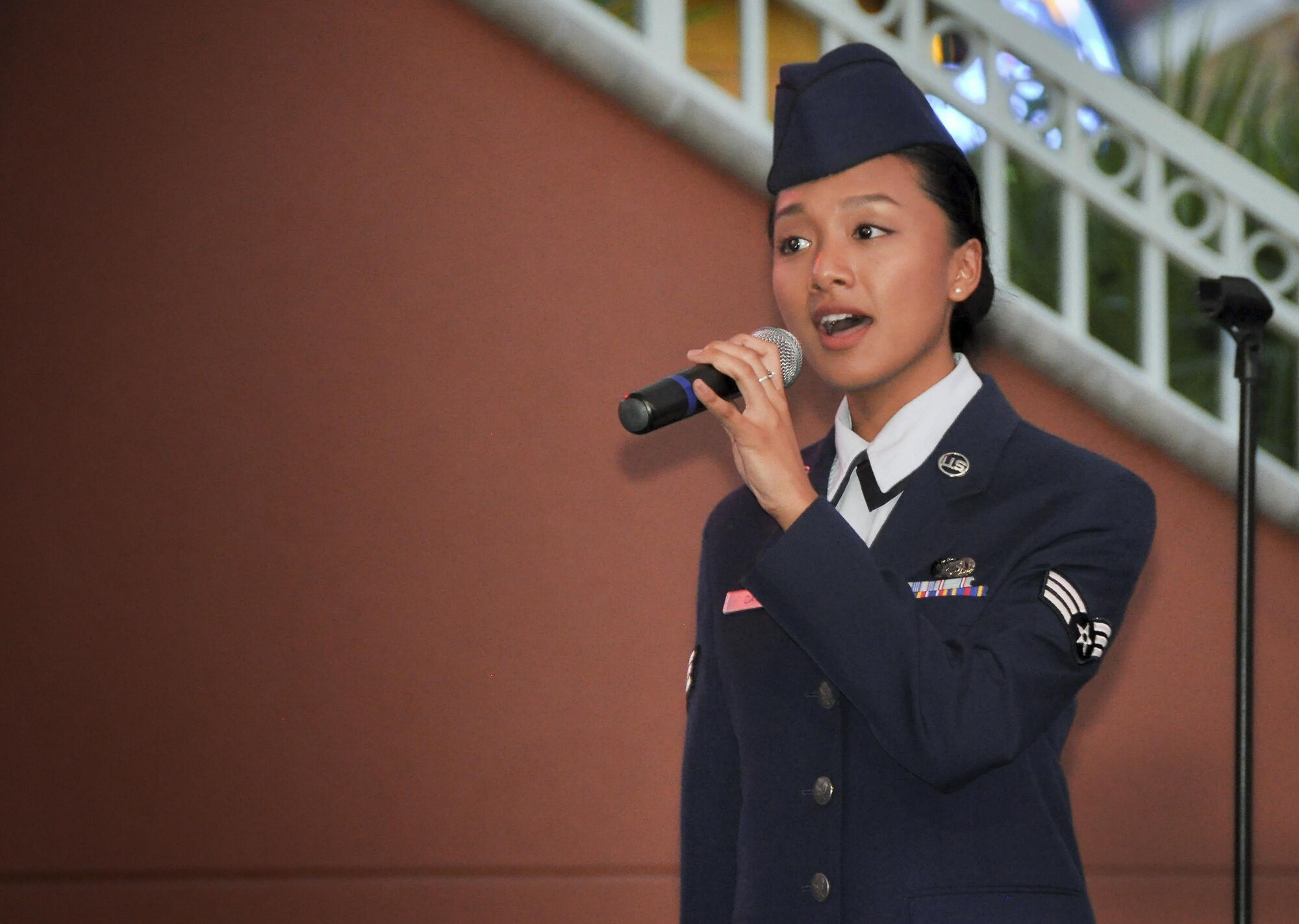 Senior Airman Christine David, 96th Aircraft Maintenance Squadron and former Tops in Blue singer, belts out the National Anthem during the Harborwalk Village’s Red, White and Blue Hero celebration Aug. 25 in Destin, Fla.  (U.S. Air Force photo/Lt. Col. James Wilson)  