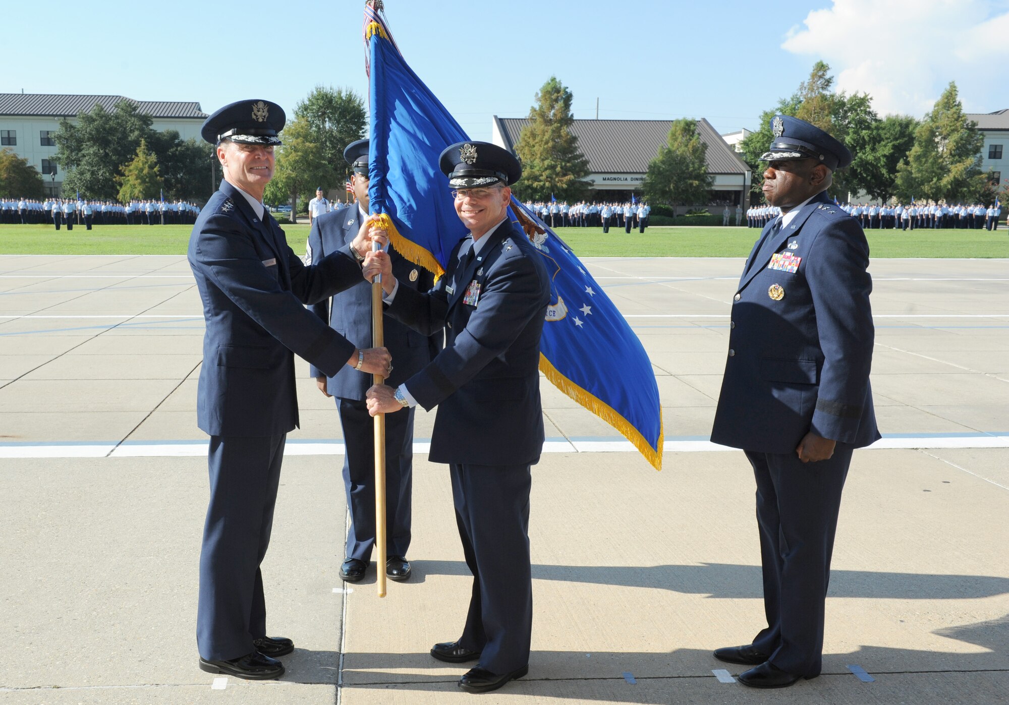 Lt. Gen. Darryl Roberson, commander, Air Education and Training Command, passes the 2nd Air Force flag to Maj. Gen. Bob LaBrutta, incoming 2nd AF commander, during the 2nd AF change of command ceremony at the Levitow Training Support Facility Aug. 26, 2016, on Keesler Air Force Base, Miss. LaBrutta was previously the 502nd Air Base Wing and Joint Base San Antonio, Texas, commander and assumed command from  Maj. Gen. Mark Brown, who is heading to Joint Base San Antonio-Randolph, Texas, where he will become the AETC vice commander. (U.S. Air Force photo by Kemberly Groue/Released)