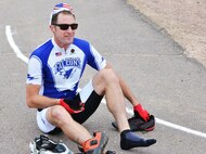 Matt Cork, 50th Operations Support Squadron, puts on his running shoes during the 12th annual Schriever Air Force Base Triathlon at Schriever Air Force Base, Colorado, Friday, Aug. 26, 2016. Cork, who finished second in the event, lost valuable time during the bike-run transition as he left his running shoes near the pool area and had to retrieve them before continuing. (U.S. Air Force photo/Brian Hagberg)