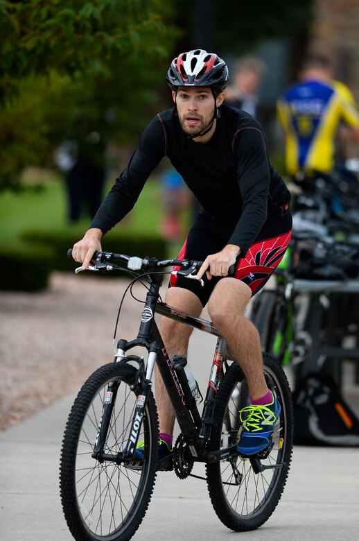 Scott Silver, Missile Defense Agency, begins the bicycle portion of the 12th annual Schriever Air Force Base Triathlon at Schriever Air Force Base, Colorado, Friday, Aug. 26, 2016. Silver finished third in the event with a time of 1:05:39. (U.S. Air Force photo/Christopher DeWitt)