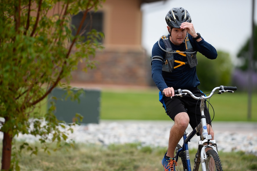 John Canaan, 1st Space Operations Squadron, heads down the bike path during the 12th annual Schriever Air Force Base Triathlon at Schriever Air Force Base, Colorado, Friday, Aug. 26, 2016. Canaan was one of 25 competitors who swam 400 meters, biked 12 miles and ran 3.1 miles. (U.S. Air Force photo/Christopher DeWitt)