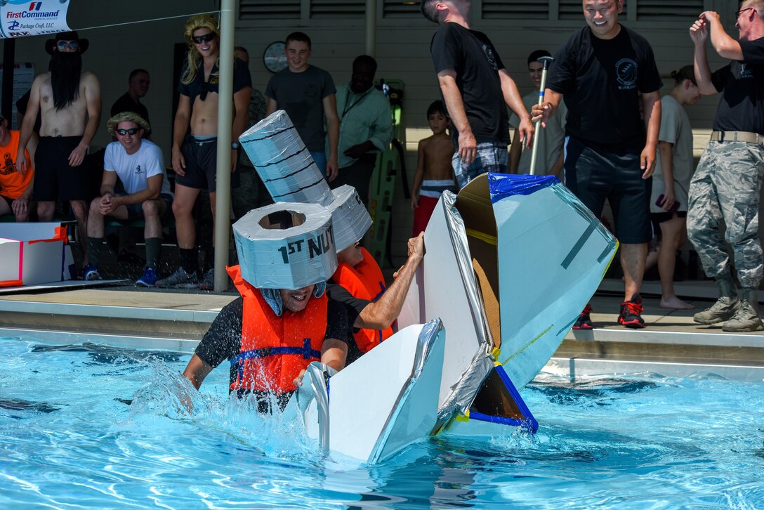 Airmen from the 4th Aircraft Maintenance Squadron sink in the pool as their cardboard boat collapses during the Build-a-Boat competition, Aug. 26, 2016, at Seymour Johnson Air Force Base, North Carolina. Airmen raced against other teams using boats built with only cardboard and duct tape. (U.S. Air Force photo by Airman Shawna L. Keyes)