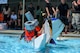 Airmen from the 4th Aircraft Maintenance Squadron sink in the pool as their cardboard boat collapses during the Build-a-Boat competition, Aug. 26, 2016, at Seymour Johnson Air Force Base, North Carolina. Airmen raced against other teams using boats built with only cardboard and duct tape. (U.S. Air Force photo by Airman Shawna L. Keyes)