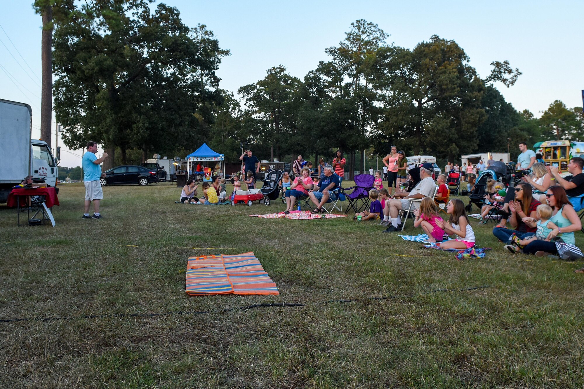 Members of Team Seymour watch a magic show during the postponed Independence Day celebration, Aug. 26, 2016, at Seymour Johnson Air Force Base, North Carolina. The event featured live music, food, family games, and fireworks. (U.S. Air Force photo by Airman Shawna L. Keyes) 