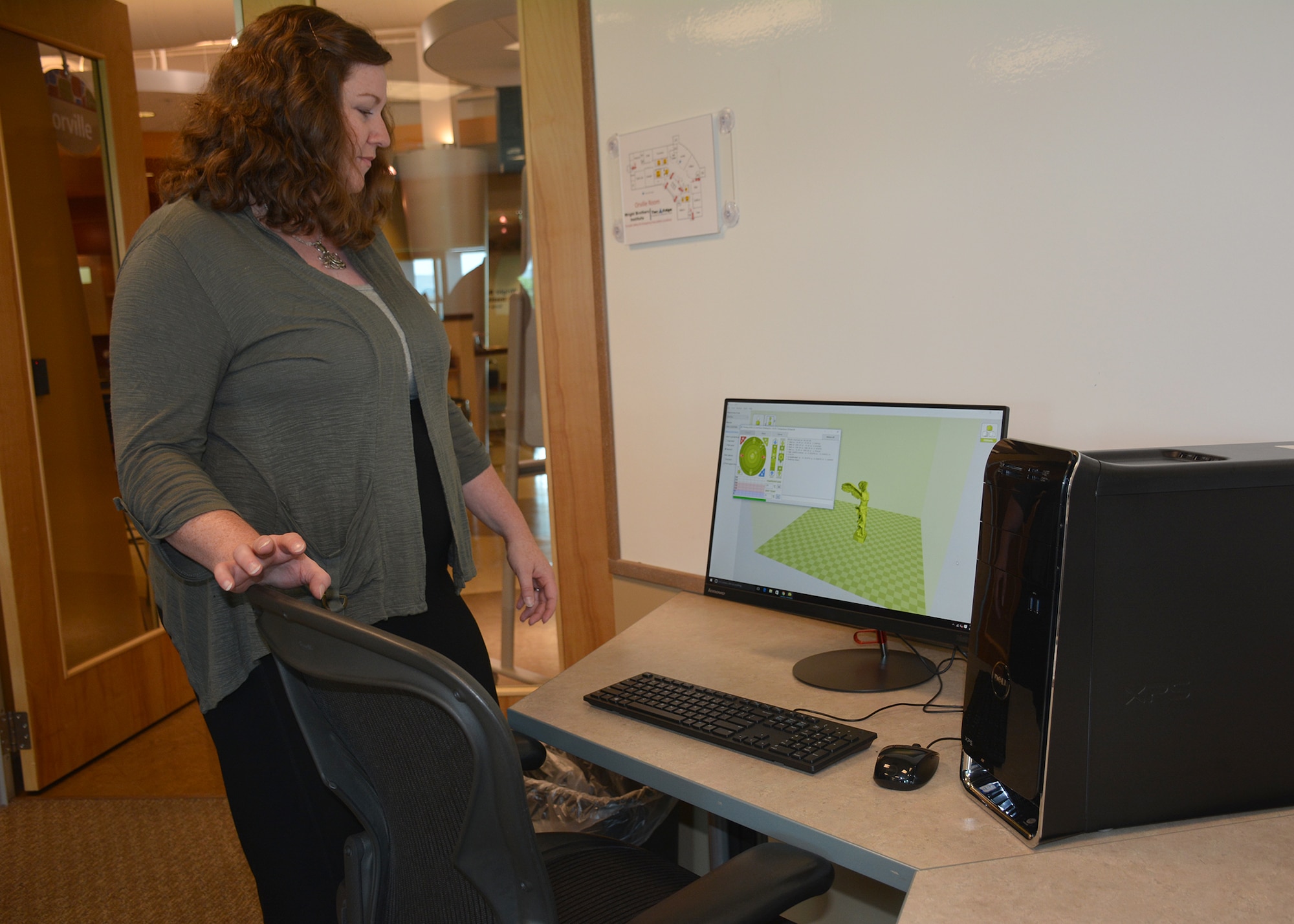 Dr. Emily Fehrman Cory, founder of the Maker Hub, demonstrates software that enables users to print their own creations using the facility’s 3-D printer.  The Maker Hub is a collaborative space that provides equipment and a social environment for Wright-Patterson employees to experiment with their own creations. (U.S. Air Force photo/Lori Hughes)