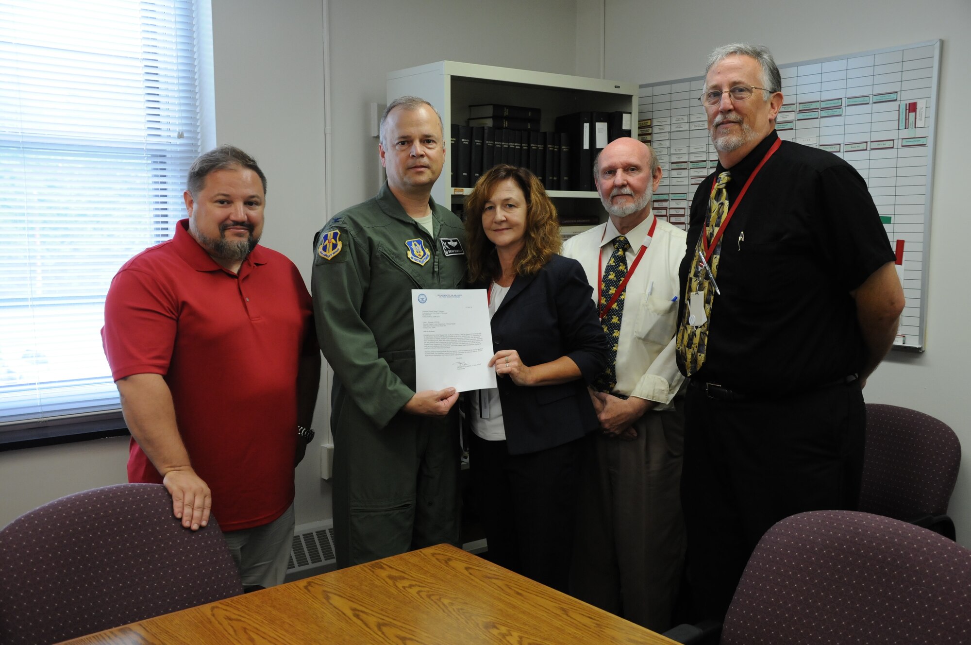 Col. Brian Bowman, commander, 914th Airlift Wing and Dan Norton (left), director of Psychological Health, 914 AW, pose for a photo with Laura Kellemen, director, Niagara County Department of Mental Health, Michael White (right), deputy director and Jim Swift (far right), supervising social worker during a visit to their office on Aug. 25, 2016. Bowman and Dan Norton, Director of Psychological Health, 914 AW (far left) were there to present a letter of recognition. (U.S. Air Force photo by Tech. Sgt. Matthew Burke) 