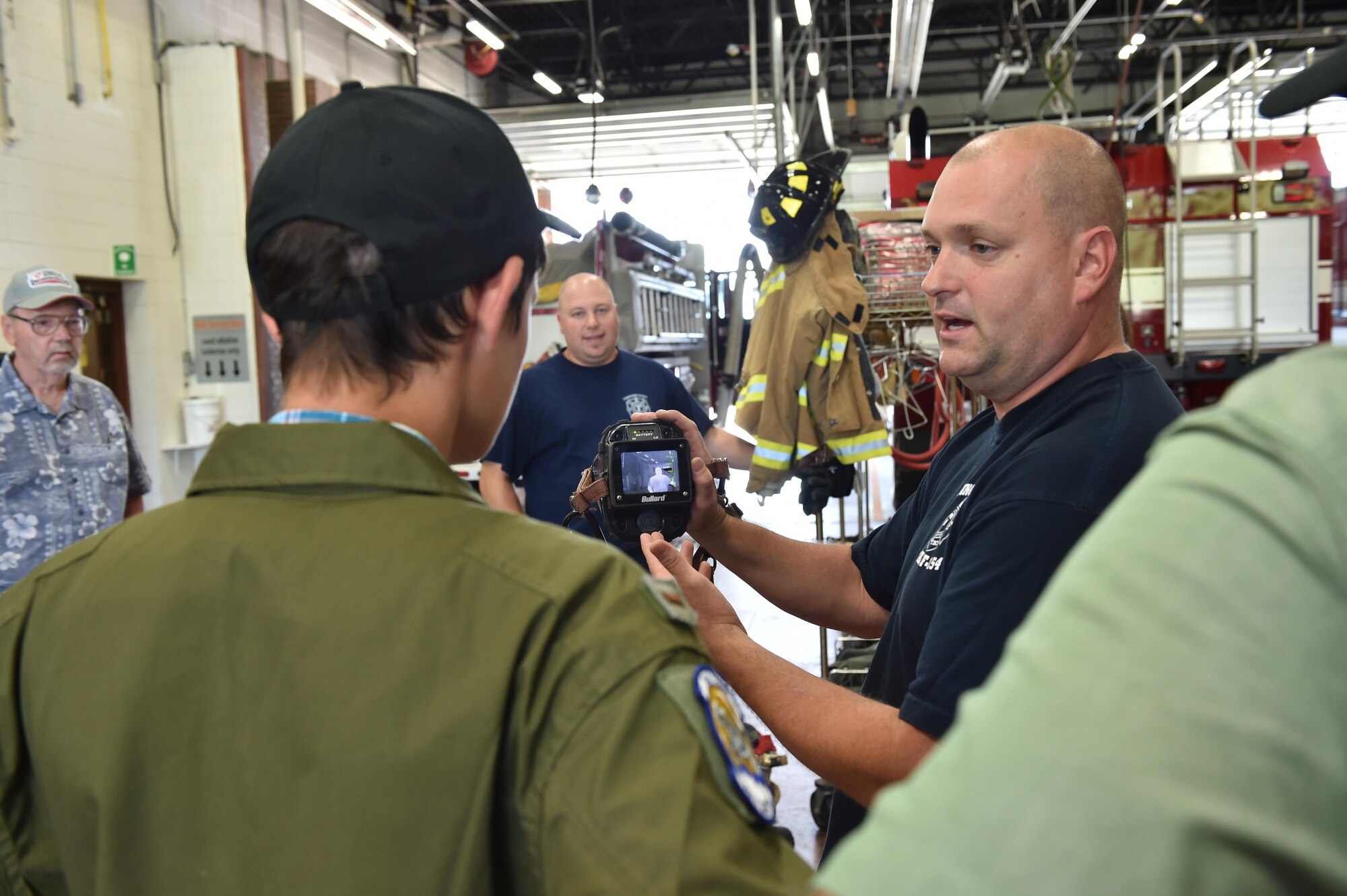 Jeff Pandrea, a firefighter with the 910th Civil Engineer Squadron fire department, shows 14-year-old Jacob Spithaler how to use a thermal imaging camera here, Aug. 24, 2016. Spithaler was the 64th honoree of the 910th Airlift Wing’s Pilot for a Day Program in which children with chronic or life-threatening illnesses are welcomed to the station, commissioned as honorary second lieutenants and treated to a day of fun military themed activities. As part of the program, Spithaler toured the base fire department and manned the water turret aboard a crash and rescue truck.  (U.S. Air Force photo/Eric White)