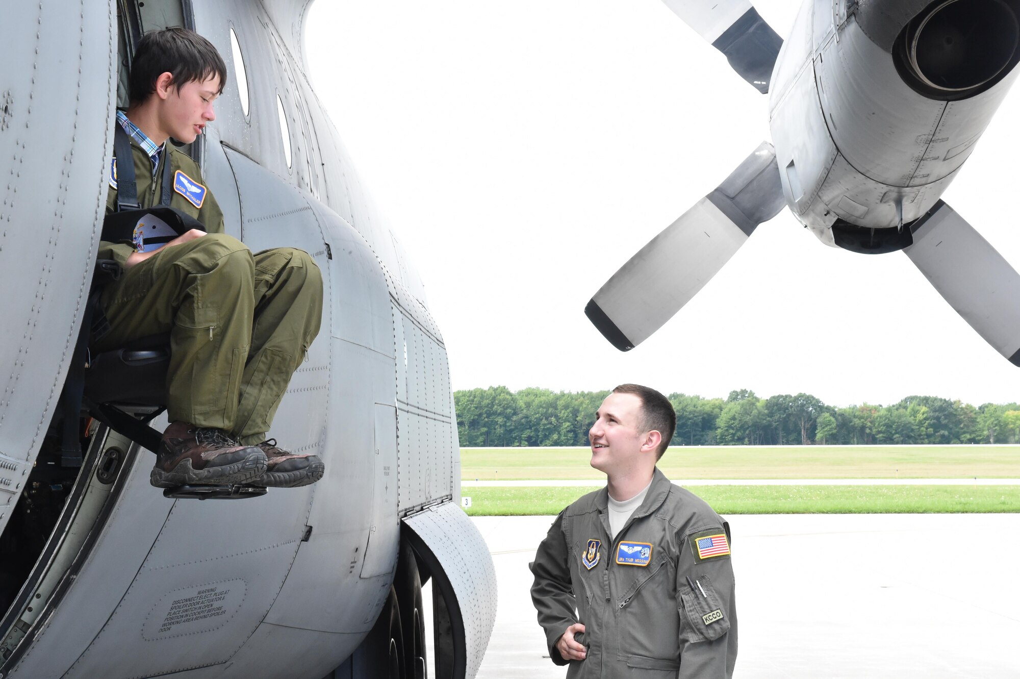 Jacob Spithaler, 14, tries out the loadmaster seat of a C-130H Hercules aircraft while Senior Airman Tyler Messina, a loadmaster with the 757th Airlift Squadron, talks about the cargo plane here, Aug. 24, 2016. Spithaler was the 64th honoree of the 910th Airlift Wing’s Pilot for a Day Program in which children with chronic or life-threatening illnesses are welcomed to the station, commissioned as honorary second lieutenants and treated to a day of fun military themed activities. Spithaler later sat in the flight deck of the aircraft while taxiing down the runway. (U.S. Air Force photo/Eric White)