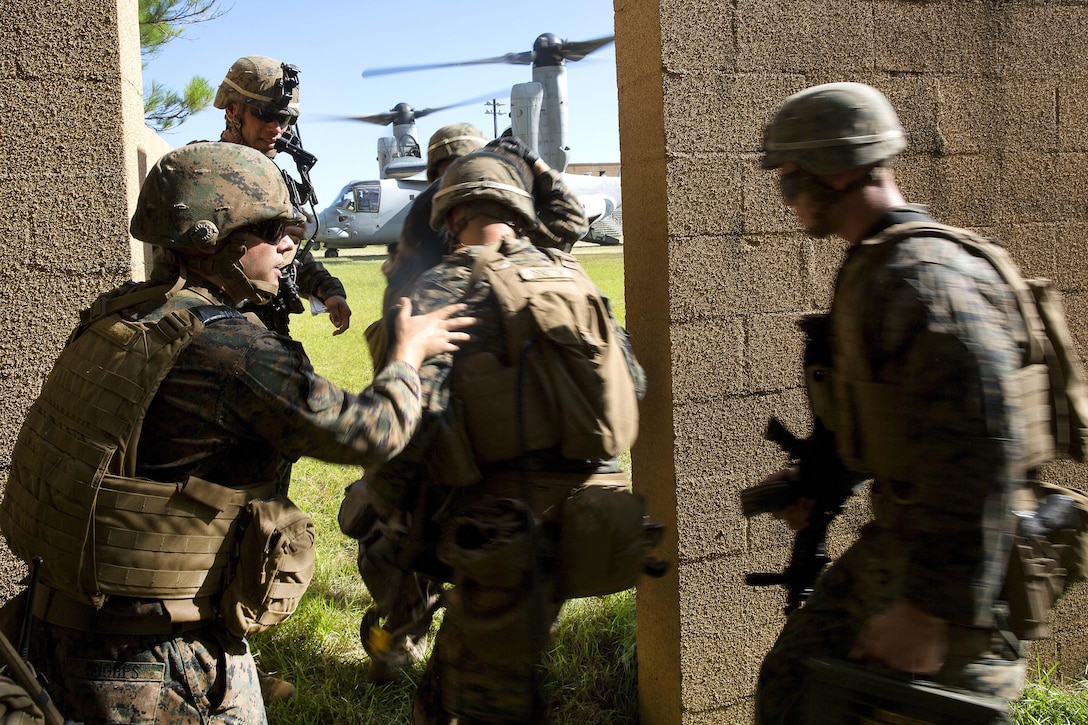 Marines rush to board an MV-22 Osprey during a vertical assault training raid at Camp Lejeune, N.C., Aug. 23, 2016. Marine Corps photo by Lance Cpl. Hernan Vidana