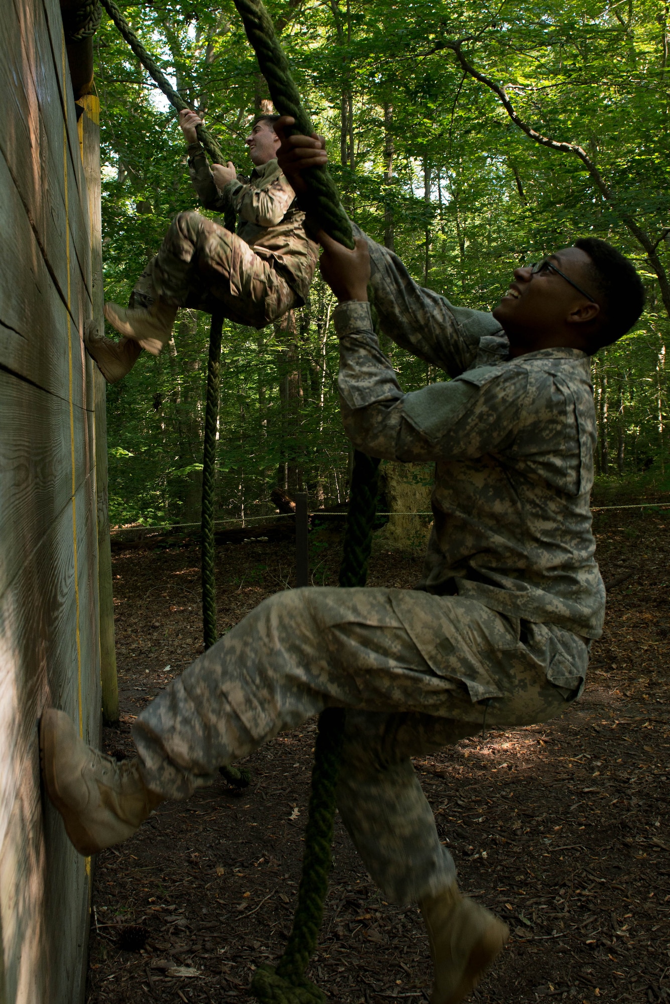 U.S. Army Spcs. Curtis Smith and Rico Ratley, 335th Transportation Detachment watercraft operators, climb a wall at Fort Eustis, Va., Aug. 25, 2016. The 335th has been inactivated and re-activated several times through its history, and in November 1987 the detachment was re-designated and activated at Fort Eustis. (U.S. Air Force photo by Airman 1st Class Derek Seifert)