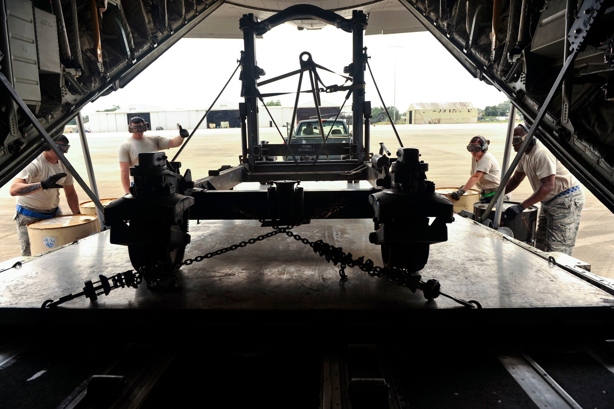 Airmen from the 305th Aerial Port Squadron at Joint Base McGuire-Dix-Lakehurst, New Jersey, uses combat offload method B to remove a C-130 engine stand trailer unit Aug. 26, 2016, at a landing zone in Alexandria, Louisiana. The combat offload method B uses barrels as a foundation for the pallets to hold the trailer as the C-130 slowly moves forward to release the equipment. (U.S. Air force photo by Staff Sgt. Regina Edwards)  