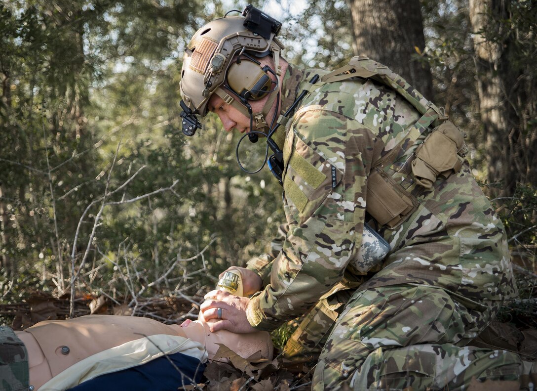 Capt. Chuck Anderson, 711th Special Operations Squadron, performs combat first aid on a simulated victim during a training session at Duke Field, Fla.  Anderson is a combat aviation advisor. A CAA mission sends a small team of Airmen to assess, advise, train, and assist friendly and allied forces with their own airpower resources.  The training aims to improve the partner nation's air capabilities quickly and show them a way to move forward effectively.  (U.S. Air Force photo/Tech. Sgt. Sam King)  