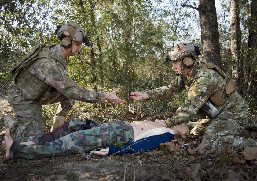Tech. Sgt. David Mobley and Capt. Chuck Anderson, 711th Special Operations Squadron, perform combat first aid on a simulated victim during a training session at Duke Field, Fla.  The Airmen are combat aviation advisors.  A CAA mission sends a small team of Airmen to assess, advise, train, and assist friendly and allied forces with their own airpower resources.  The training aims to improve the partner nation's air capabilities quickly and show them a way to move forward effectively.  (U.S. Air Force photo/Tech. Sgt. Sam King)  