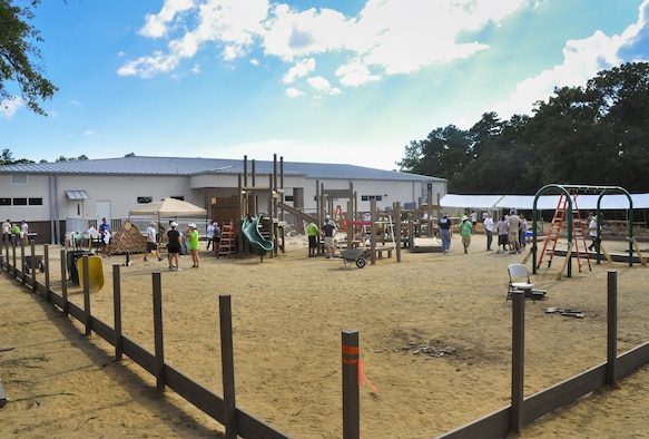 Local military and community volunteers work to construct new playground and therapy equipment at the Emerald Coast Autism Center in Niceville, Fla., Aug. 26.  The volunteers included more than 80 members of the 919th Special Operations Wing who spent a week working on the project to benefit autistic and disabled students at the center on the campus of Northwest Florida State College.  (U.S. Air Force photo/Dan Neely)