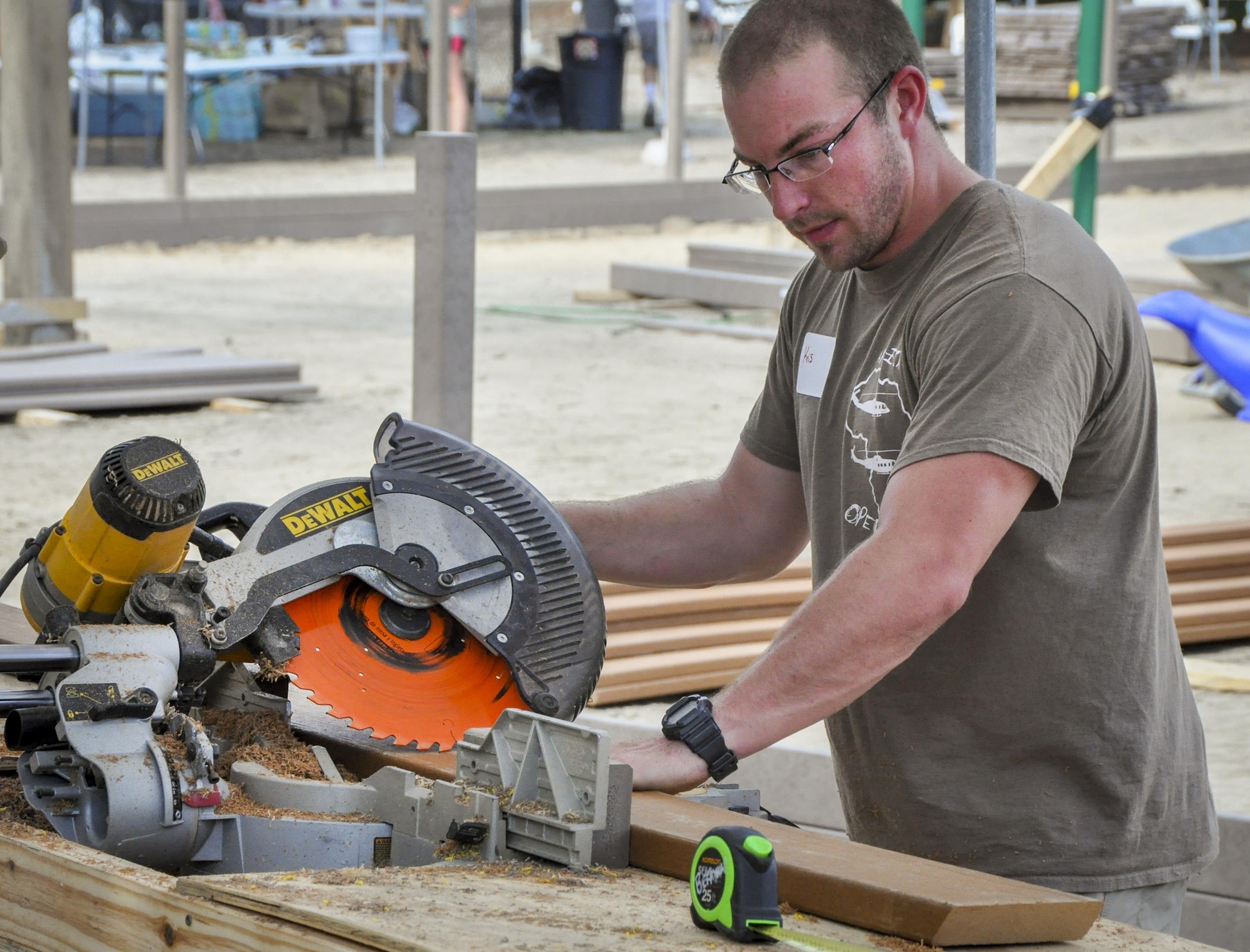 Staff Sgt. Kristopher Golden, 919th Special Operations Aircraft Maintenance Squadron, uses a circular saw to cut wood plank sections at the Emerald Coast Autism Center in Niceville, Fla. Aug. 26.   Golden and more than 80 other 919th Special Operations Wing volunteers spent a week helping construct new playground and therapy equipment to benefit autistic and disabled students at the center on the campus of Northwest Florida State College.  (U.S. Air Force photo/Dan Neely) 