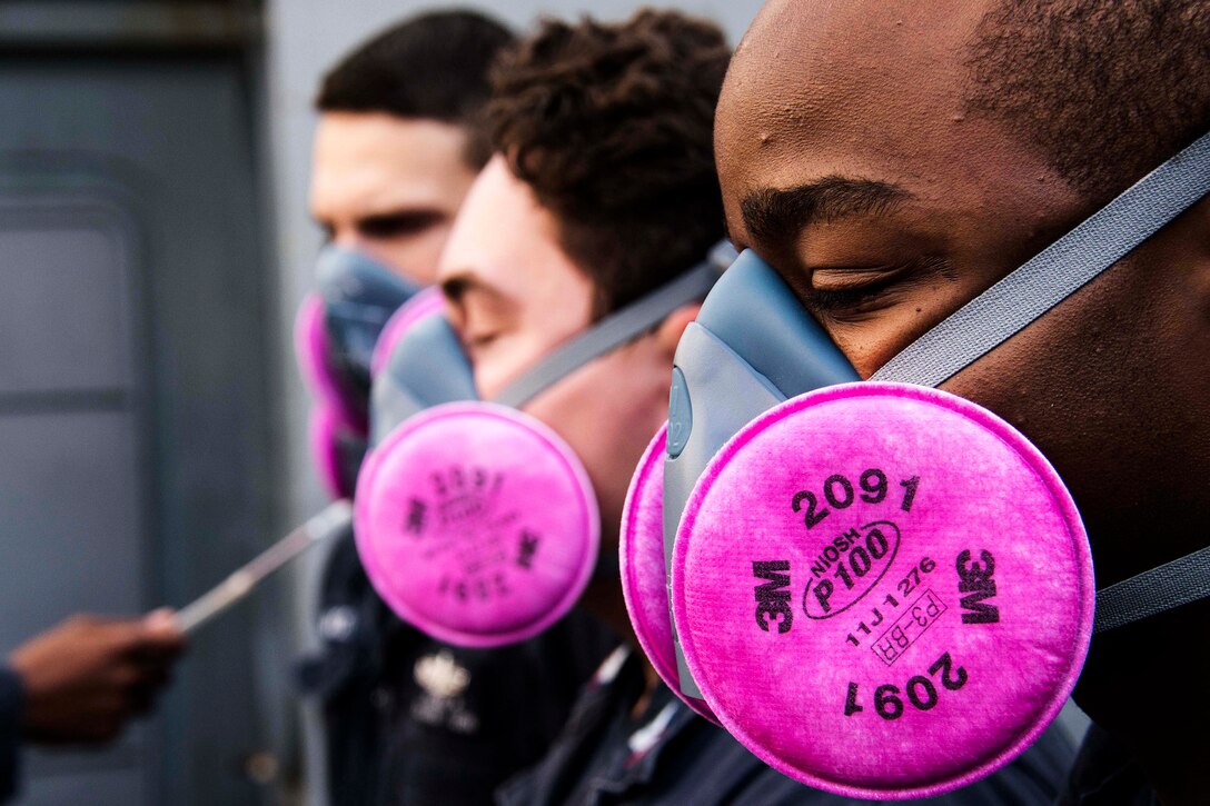 Sailors perform a respirator fit test aboard the USS Green Bay in the Pacific Ocean, Aug. 29, 2016. The amphibious transport dock ship is operating in the U.S. 7th Fleet area of operations to support security and stability in the Indo-Asia-Pacific region. Navy photo by Petty Officer 1st Class Chris Williamson
