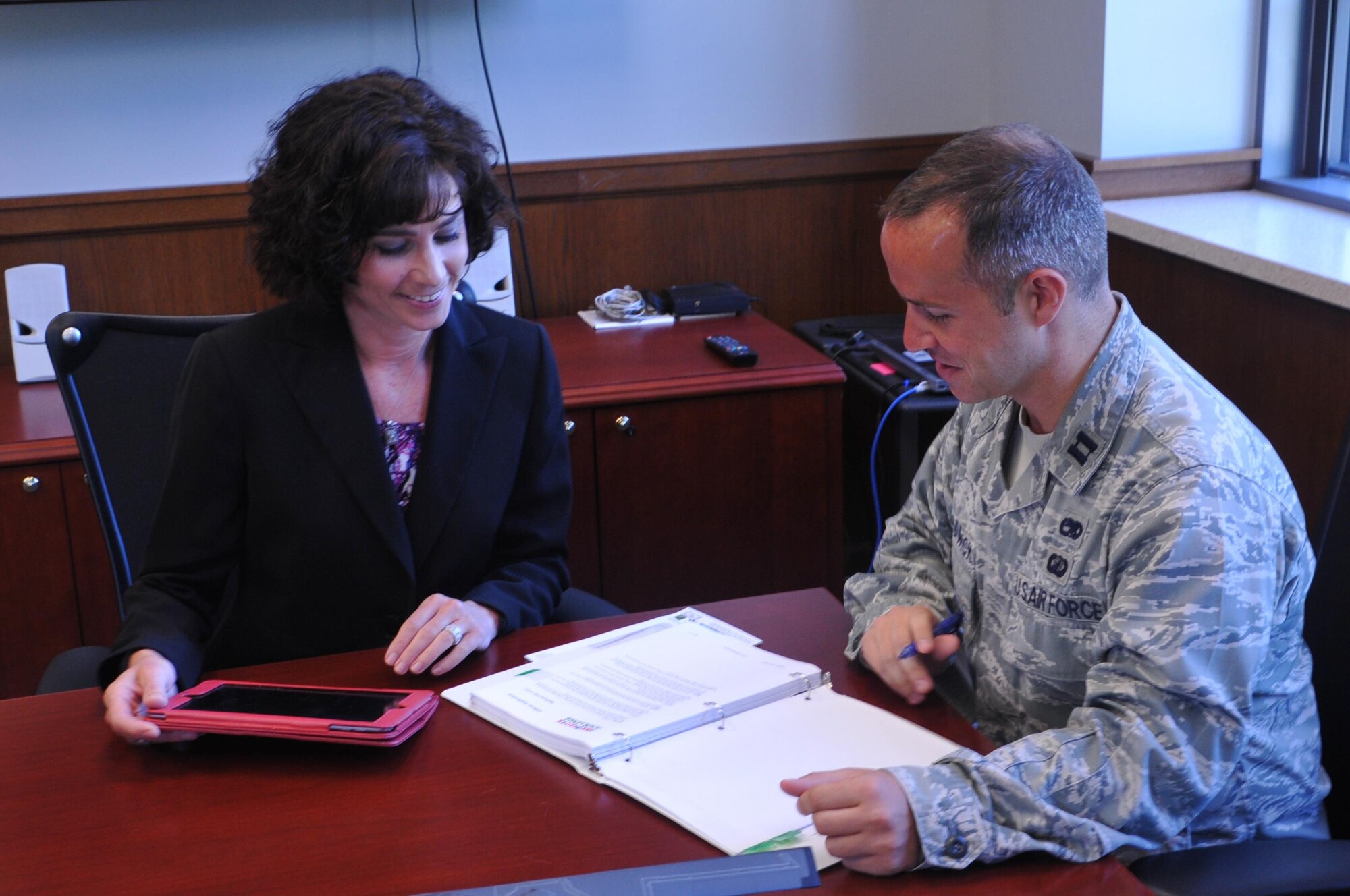 Lynda Rutledge (L), program executive officer and director of the Air Force Life Cycle Management Center's Agile Combat Support Directorate confers with Capt. James Hardwick, executive officer of ACS. (U.S. Air Force photo / Brian Brackens)