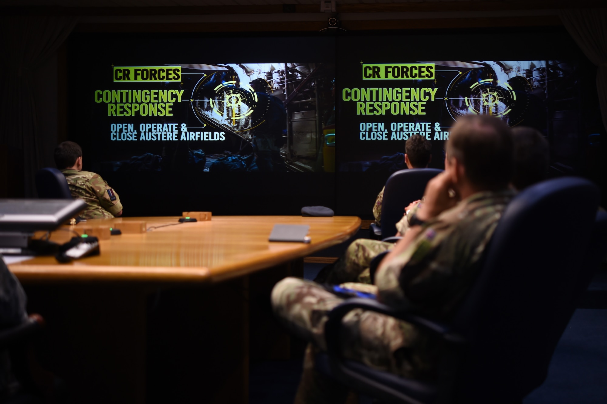 Members of the United Kingdom Royal Air Force Expeditionary Air Wing watch the 621st Contingency Response Wing mission video during a visit at Joint Base McGuire-Dix-Lakehurst, New Jersey, August 22, 2016. The EAW is the RAF version of the CRW. (U.S. Air Force photo by Tech. Sgt. Gustavo Gonzalez)