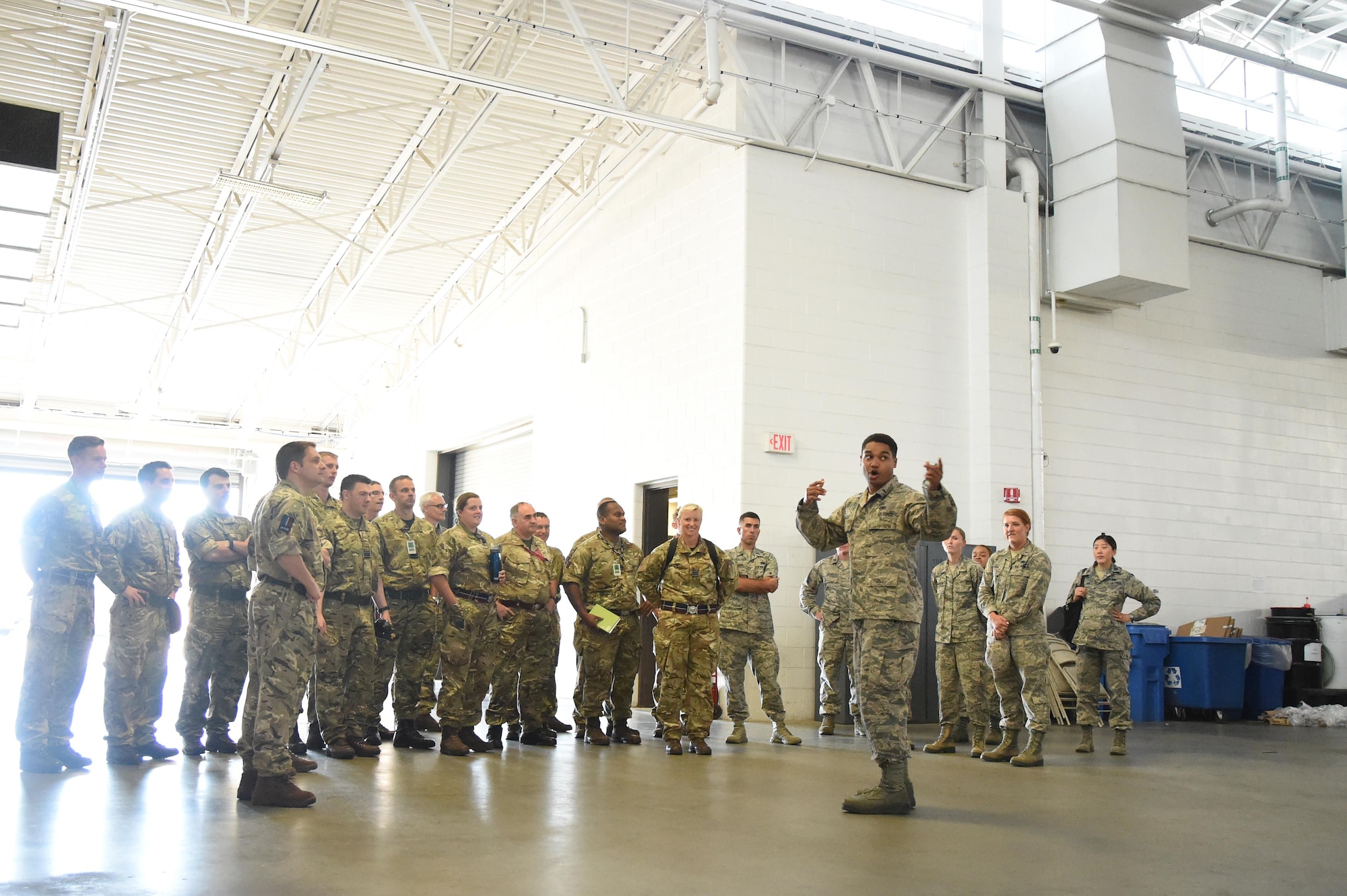 U.S. Air Force 1st Lt. Daniel Wilson, 621st Contingency Response Support Squadron operations flight commander, speaks to members of the United Kingdom Royal Air Force Expeditionary Air Wing during a tour at Joint Base McGuire-Dix-Lakehurst, New Jersey, August 22, 2016. The RAF members toured the Global Reach Deployment Center, a storage facility where most of the equipment for the CRW is kept. (U.S. Air Force photo by Tech. Sgt. Gustavo Gonzalez)