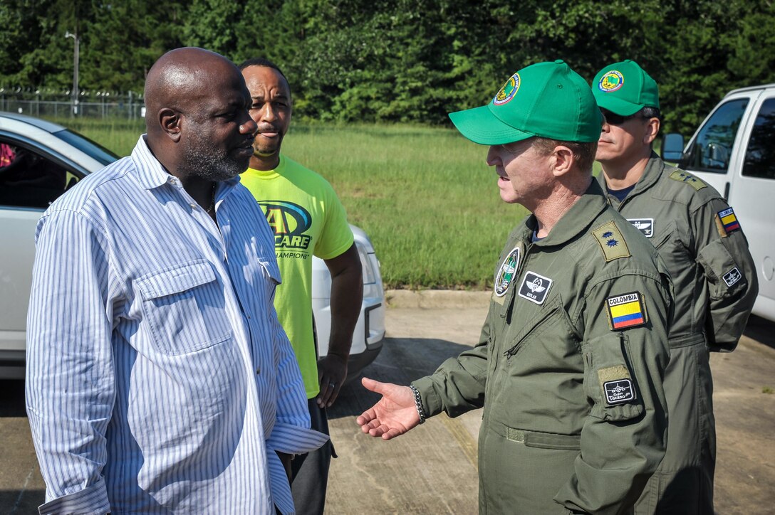 Colombian Air Force Brig. Gen. Rodrigo Alejandro Valencia Guevara (right) speaks with Terrance Trammell, director of operations at the Bossier City, La., Salvation Army Aug. 27, 2016. Colombian Airmen visiting Barksdale Air Force Base, La., donated supplies to the local Salvation Army for delivery to relief centers in central Louisiana following weeks of torrential rain and flooding in the region. (U.S. Air Force photo / Senior Airman Mozer O. Da Cunha)