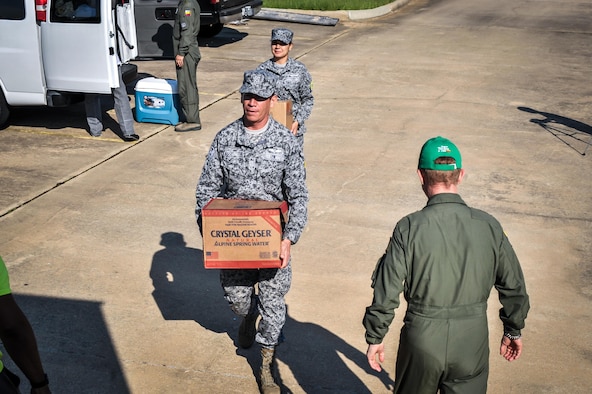 Colombian Airmen haul supplies to an awaiting Salvation Army truck in Bossier City, La., Aug. 27, 2016. Colombian Airmen visiting Barksdale Air Force Base, La., donated supplies to the local Salvation Army for delivery to relief centers in central Louisiana following weeks of torrential rain and flooding in the region. (U.S. Air Force photo / Senior Airman Mozer O. Da Cunha)