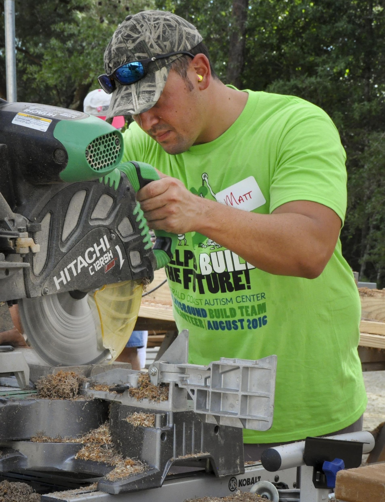 Tech. Sgt. Matthew Luecht, 919th Special Operations Maintenance Squadron, uses a circular saw to cut wood plank sections at the Emerald Coast Autism Center in Niceville, Fla. Aug. 26.   Luecht and more than 80 other 919th Special Operations Wing volunteers spent a week helping construct new playground and therapy equipment for autistic and disabled students at the center on the campus of Northwest Florida State College.  (U.S. Air Force photo/Dan Neely)  