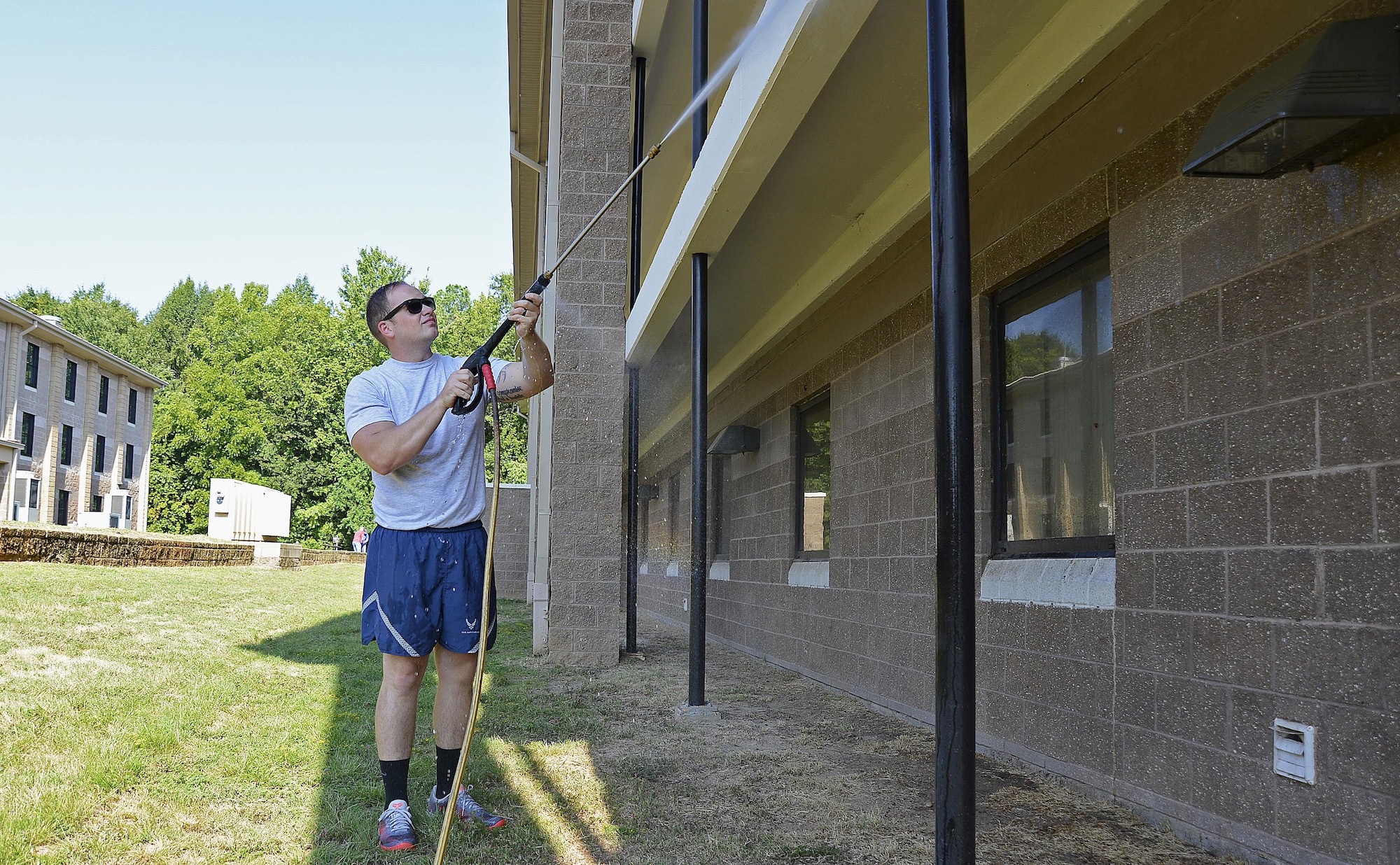 U.S. Air Force Staff Sgt. Anthony Streifel, 20th Logistics Readiness Squadron inbound cargo noncommissioned officer in charge, uses a power washer to spray down dorms to get rid of spider webs at Shaw Air Force Base, S.C., Aug. 27, 2016. Power washers make it easier to get rid of dirt and spider webs in hard-to-reach areas. (U.S. Air Force photo by Airman BrieAnna Stillman)