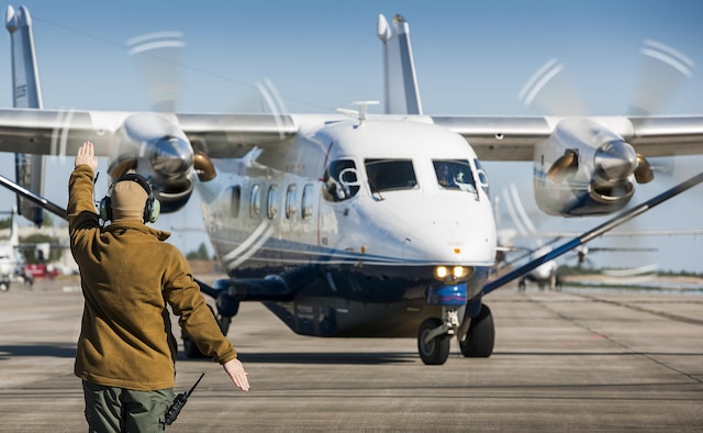 A 919th Special Operations Maintenance Group Airman marshals a C-145A Skytruck toward its mission at Duke Field, Fla.  The Skytrucks are primarily used for new aircrew qualifications and flight proficiency missions.  (U.S. Air Force photo/Tech. Sgt. Sam King) 