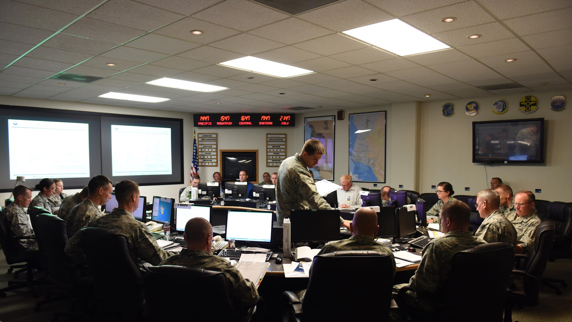 Maj. Matt Hale, 30th Operations Support Squadron operations officer, briefs the Crises Action Team during the recent tabletop exercise, Aug. 22, 2016, Vandenberg Air Force Base, Calif. While a normal base exercise for disaster response can take days, or even weeks, the most recent exercise took place in 90 minutes and only included a small fraction of the base; the CAT, the Emergency Operations Center and the launch team checklists were the primary focus. (U.S. Air Force photo by Senior Airman Ian Dudley/Released)